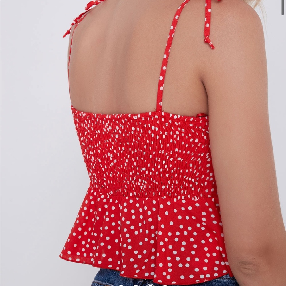 Subdued delicate red tank top with small white polka dots